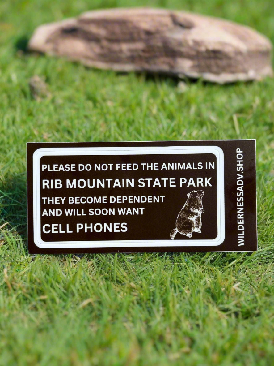Funny sticker indicating not to feed the animals or they will want cell phones with an outline of a woodchuck.