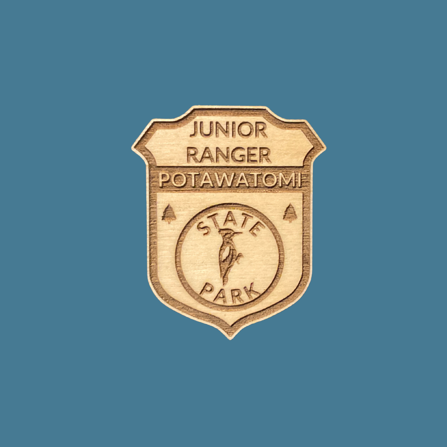 Wood badge featuring the text: “Junior Ranger Potawatomi State Park” and a woodpecker icon on a blue background.