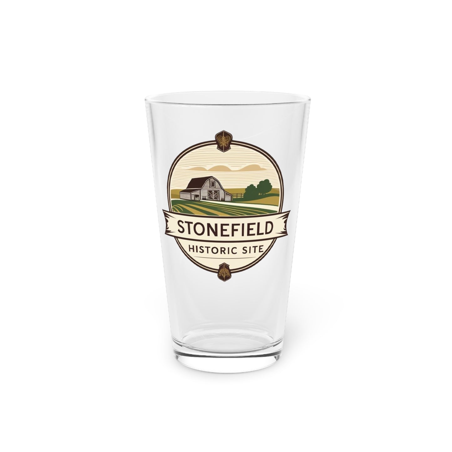16oz pint glass featuring a logo design of a barn set amongst fields.