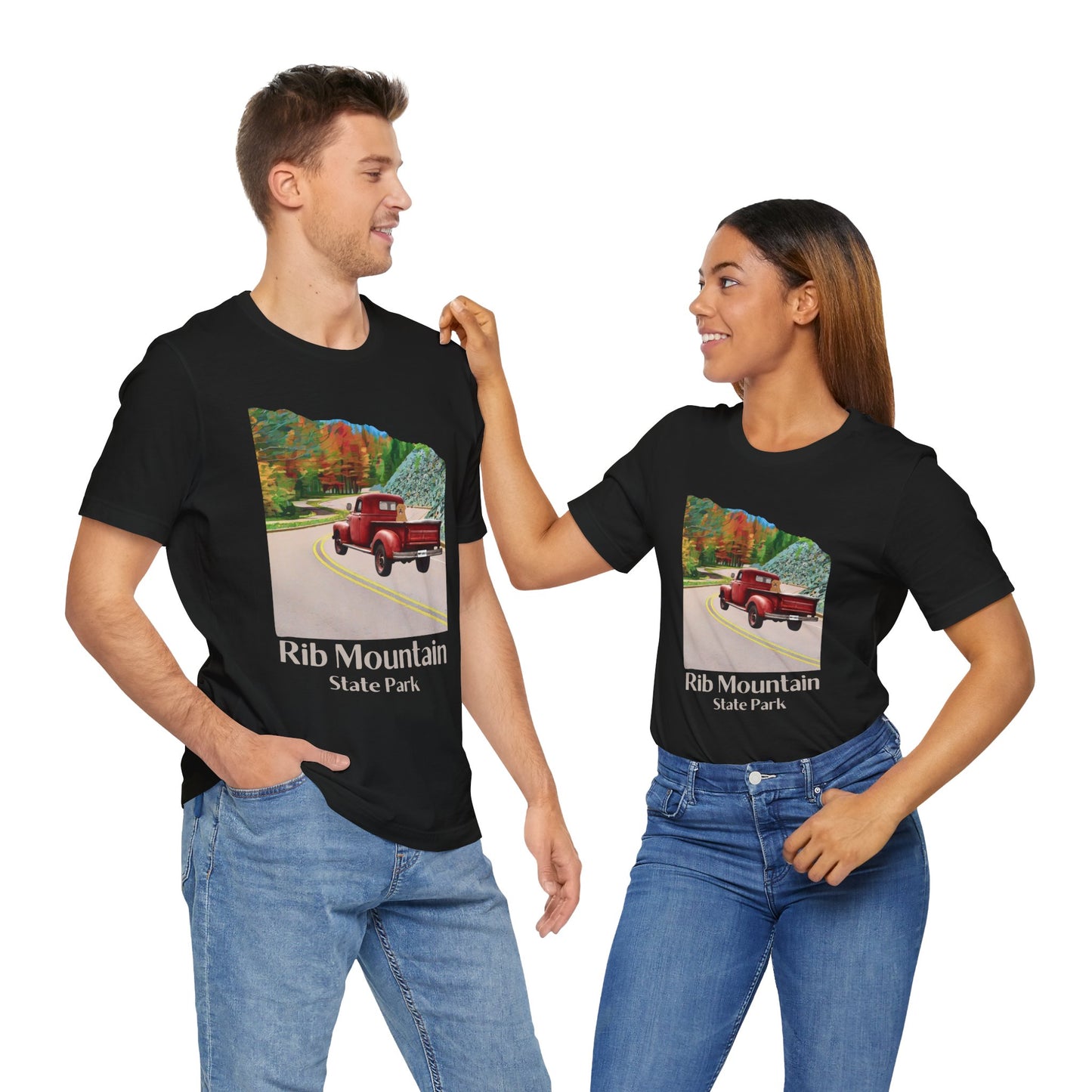Male and female model wearing black colored T-shirt with vintage truck driving up the road to Rib Mountain State Park during fall leaf color graphic.