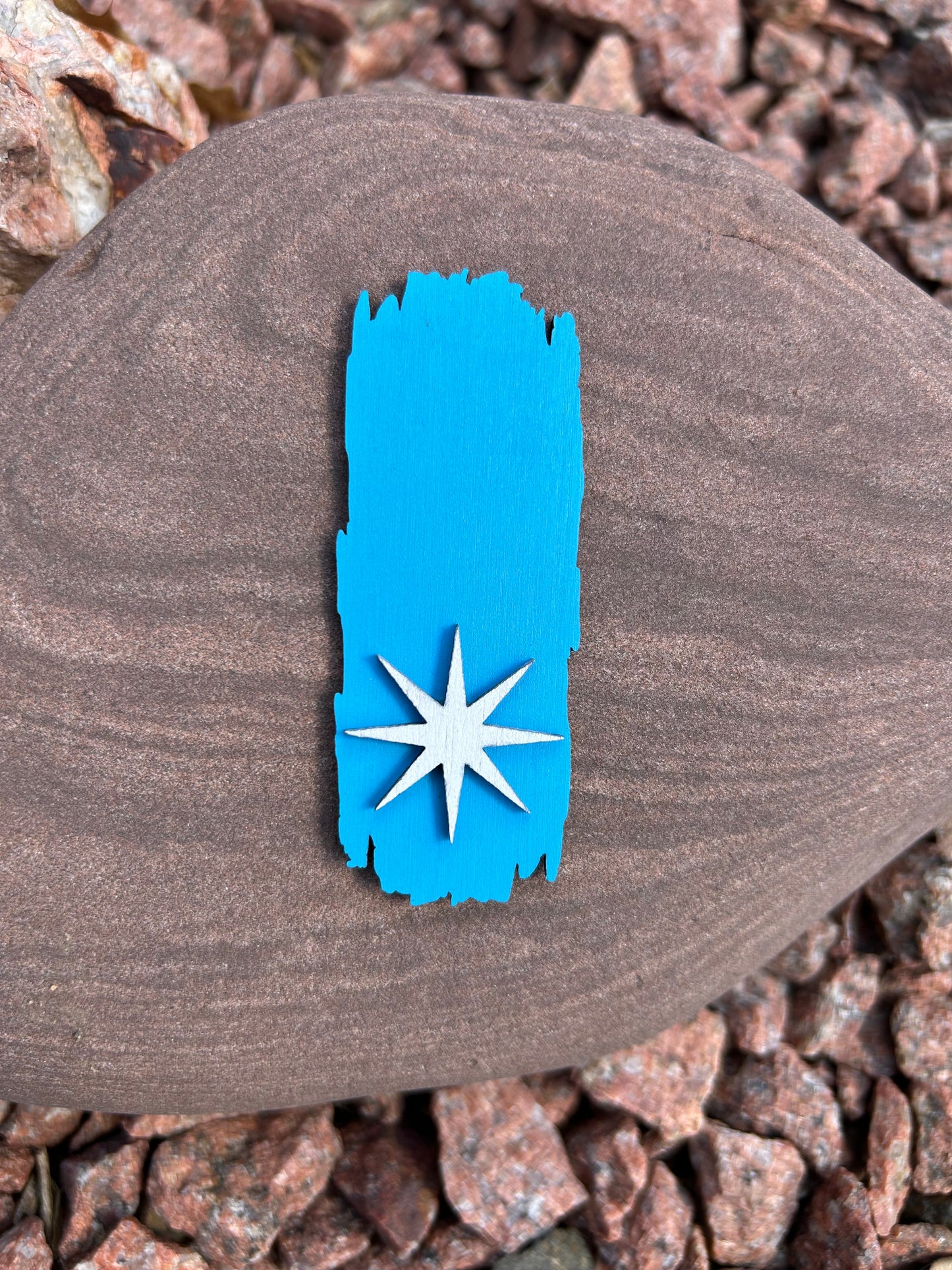 Blue painted wood National Trail Blaze magnet with a white Polaris star icon on the bottom half of the magnet.