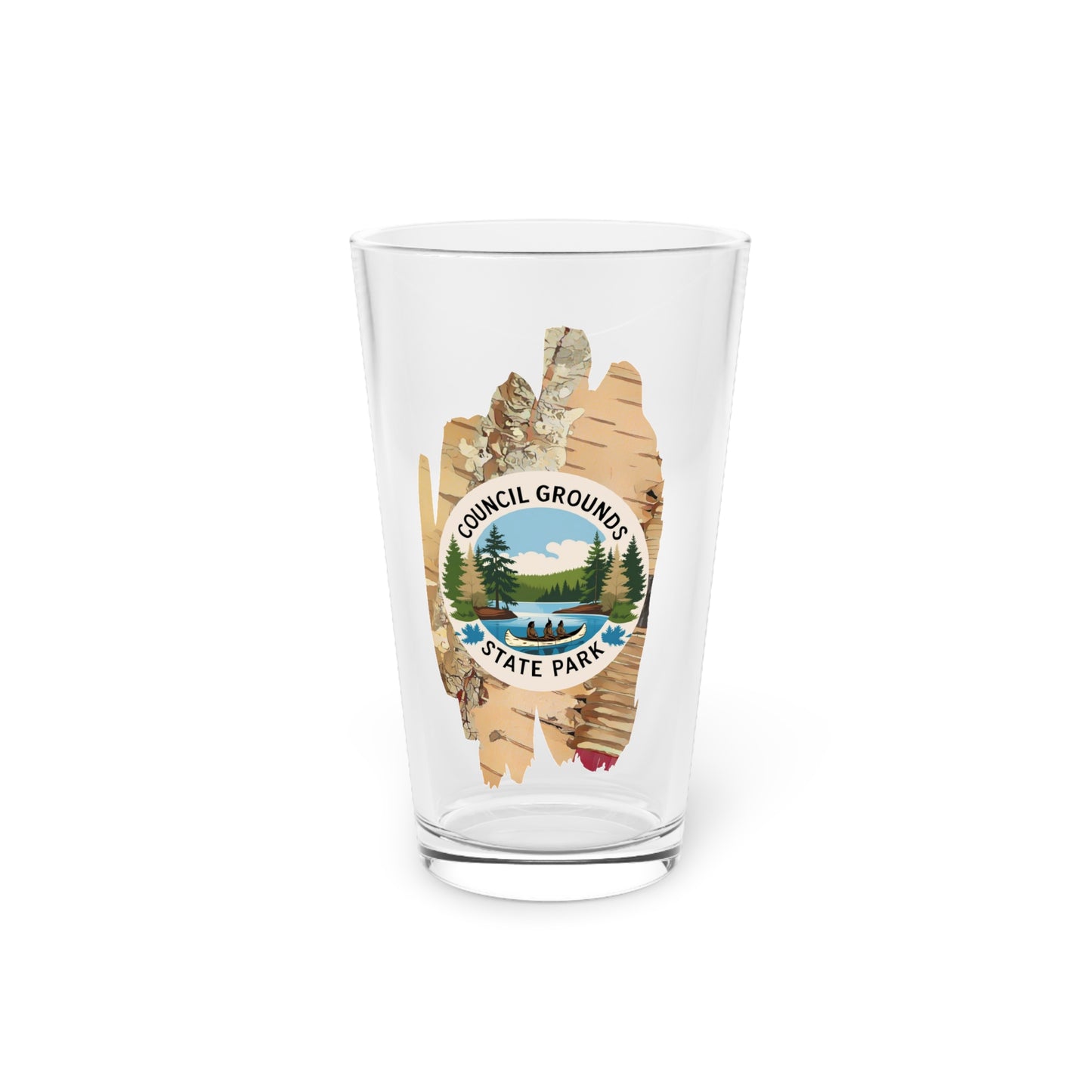 16 oz glass pint glass featuring a birch bark design with a depiction Native Americans in a birch bark canoe paddling on a river.