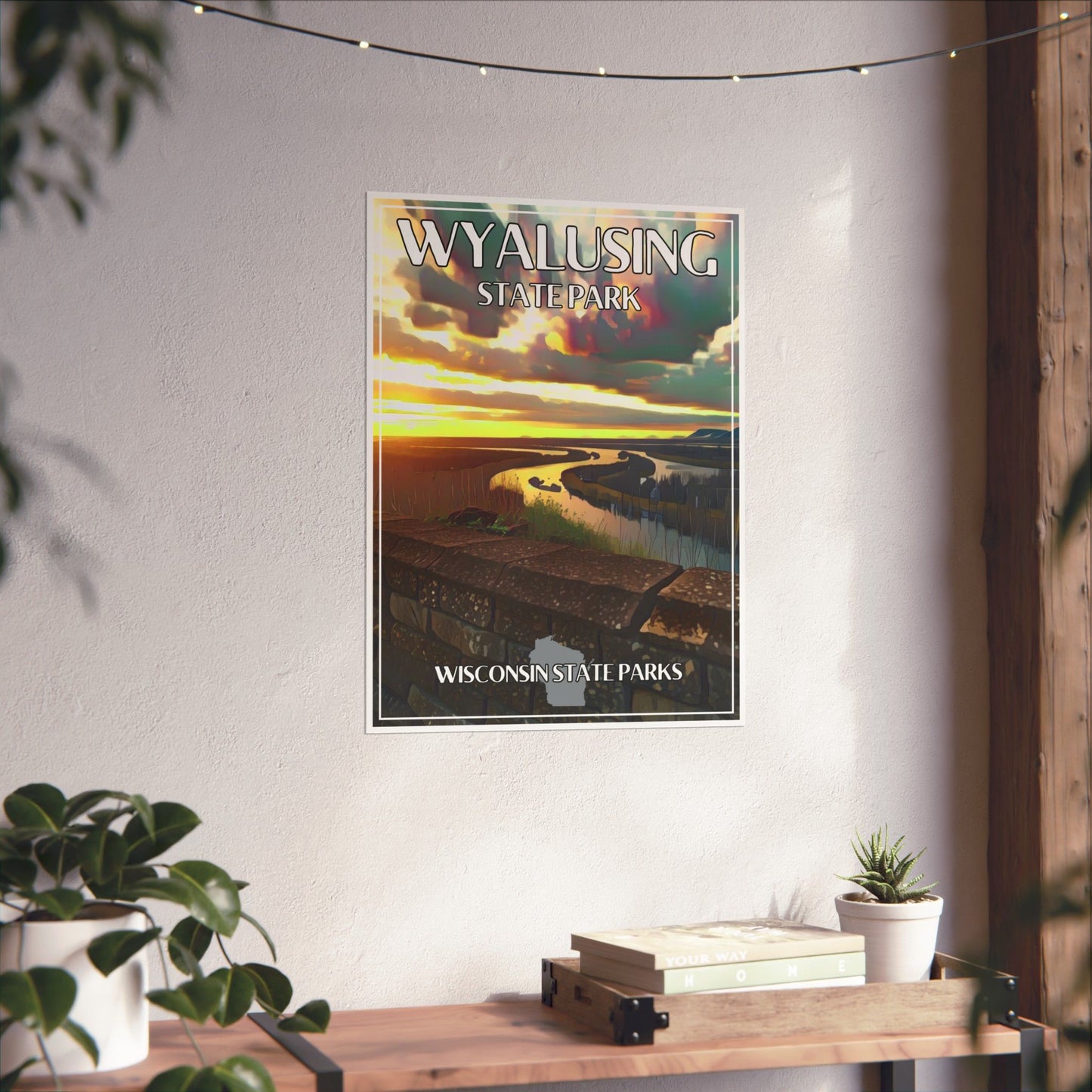 Retro CCC inspired poster depicting a scenic sunset over the confluence of rivers from a bluff-top view. Photo background: poster hanging on was above a shelf with plants and books.
