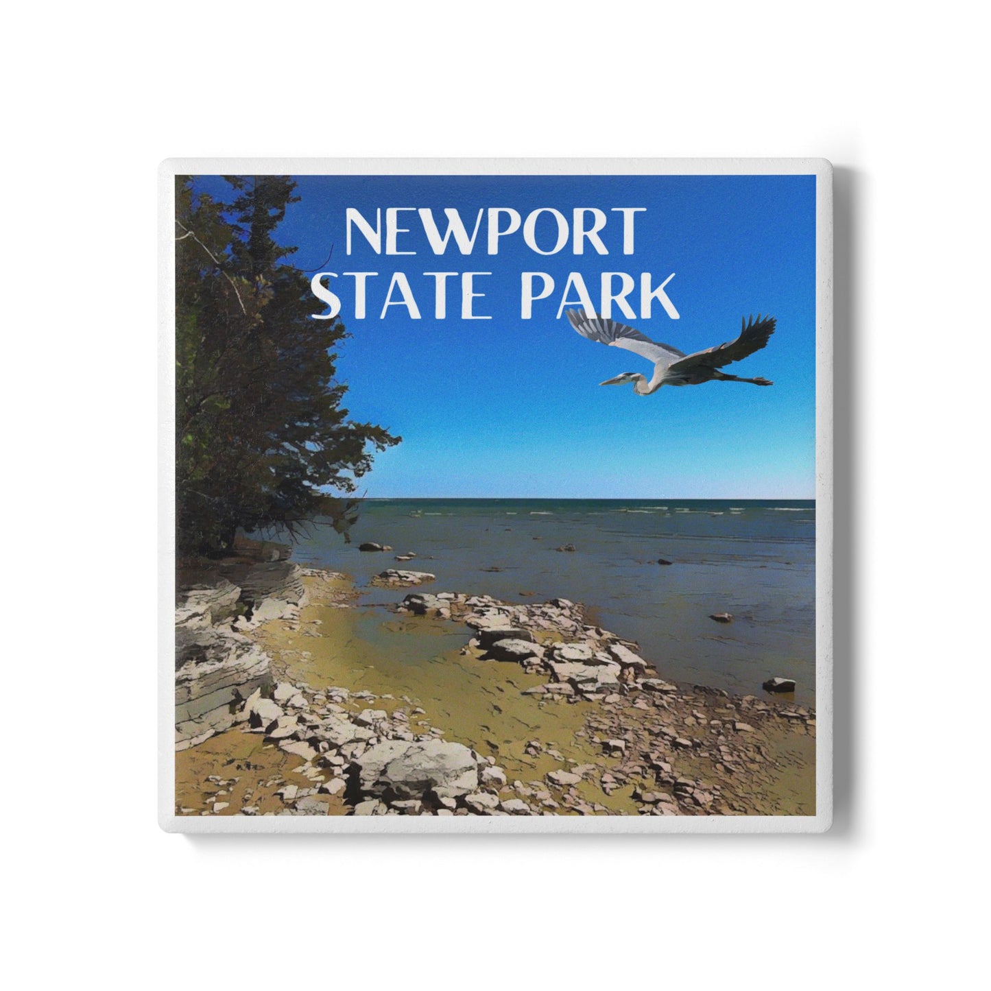 Ceramic coaster depicting the rugged shoreline of Newport State Park and a great blue heron flying in the sky. Features the text: Newport State Park.