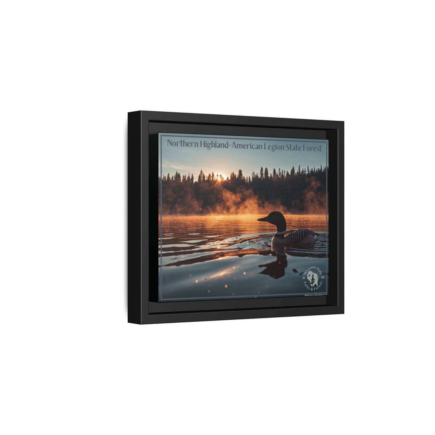 Side profile of a Black framed canvas art depicting a loon swimming on a lake in the early morning as mist rises from the water.