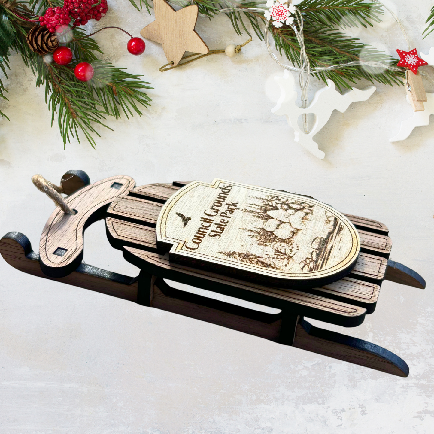Wooden sled with a label on a snowy background with Christmas decorations