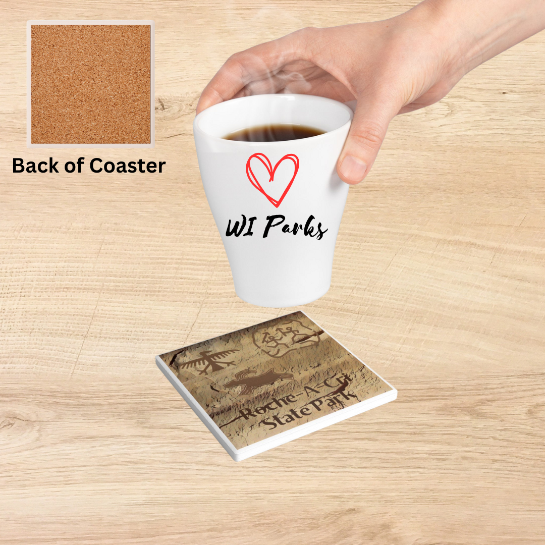Ceramic Coaster featuring petroglyphs on sandstone design and the text “Roche-A-Cri State Park. Photo Background: Coaster on counter with person setting hot beverage down on it.