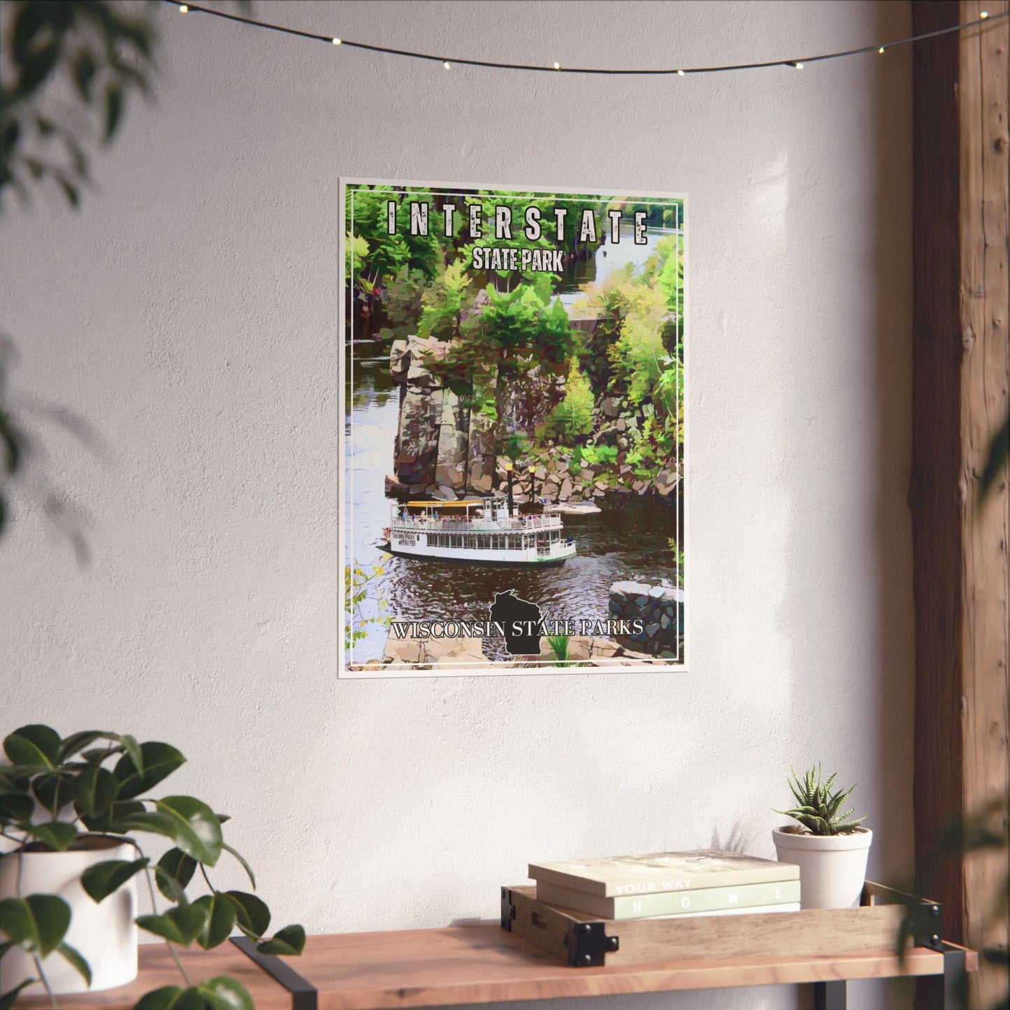 CCC style poster depicting a paddle wheel boat on the St. Croix River. Photo background: poster hanging on a wall above a shelf.