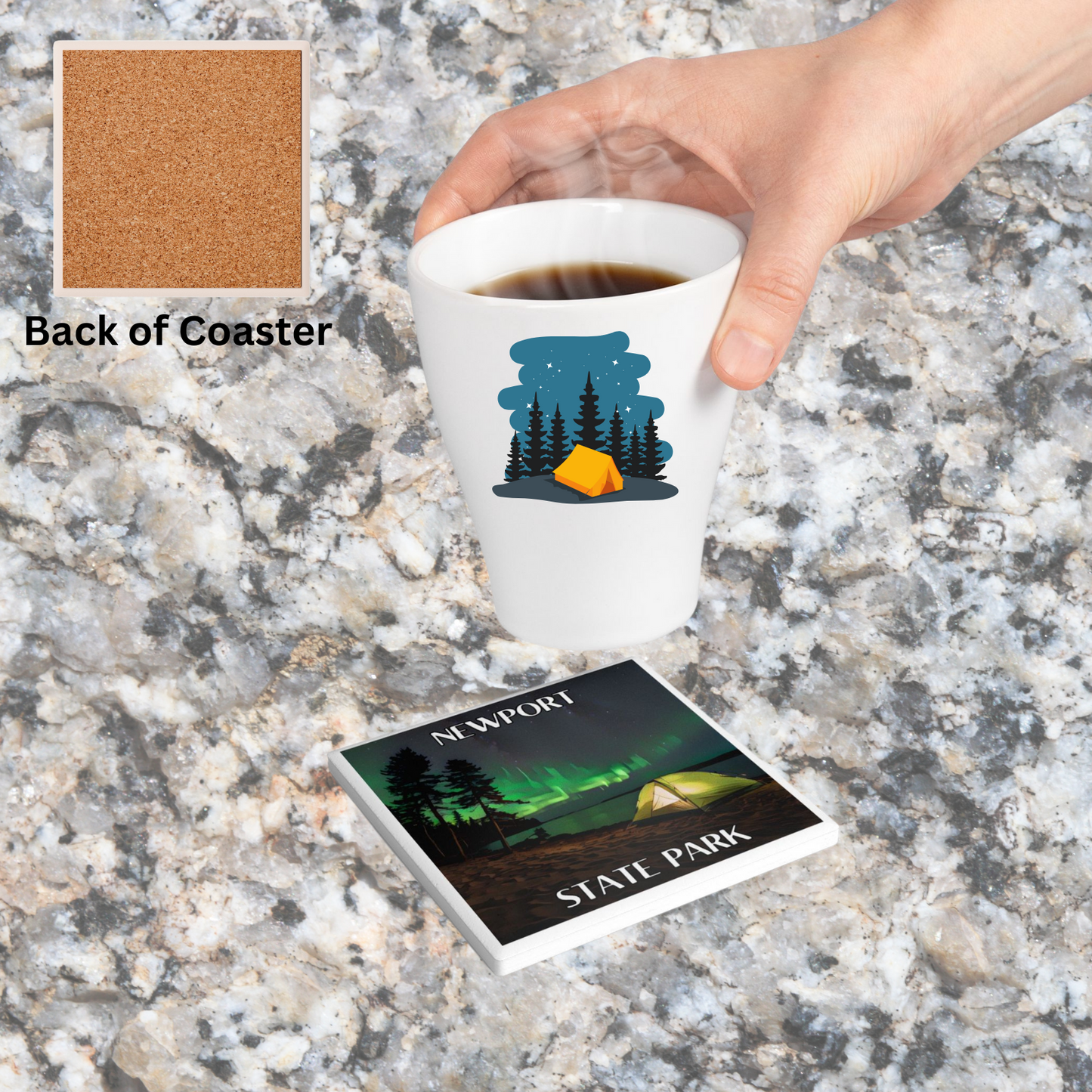 Ceramic Coaster featuring a tent on the shore of a lake and northern lights in the sky. Features the Text: Newport State Park. Photo background: coaster sitting on granite counter and individual placing hot beverage down.