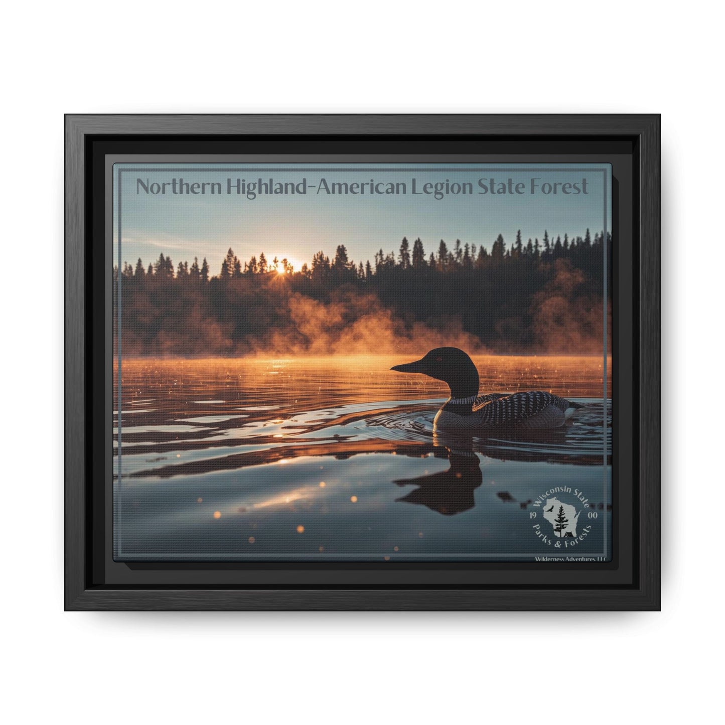 Black framed canvas art depicting a loon swimming on a lake in the early morning as mist rises from the water.