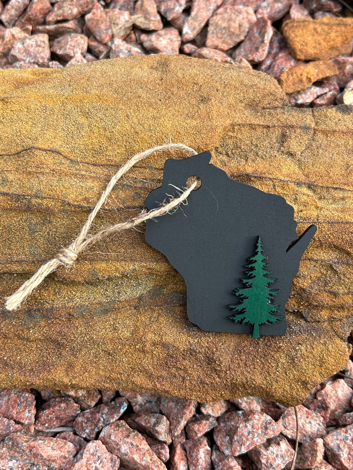 Black Wisconsin Shaped ornament with a green pine tree icon.