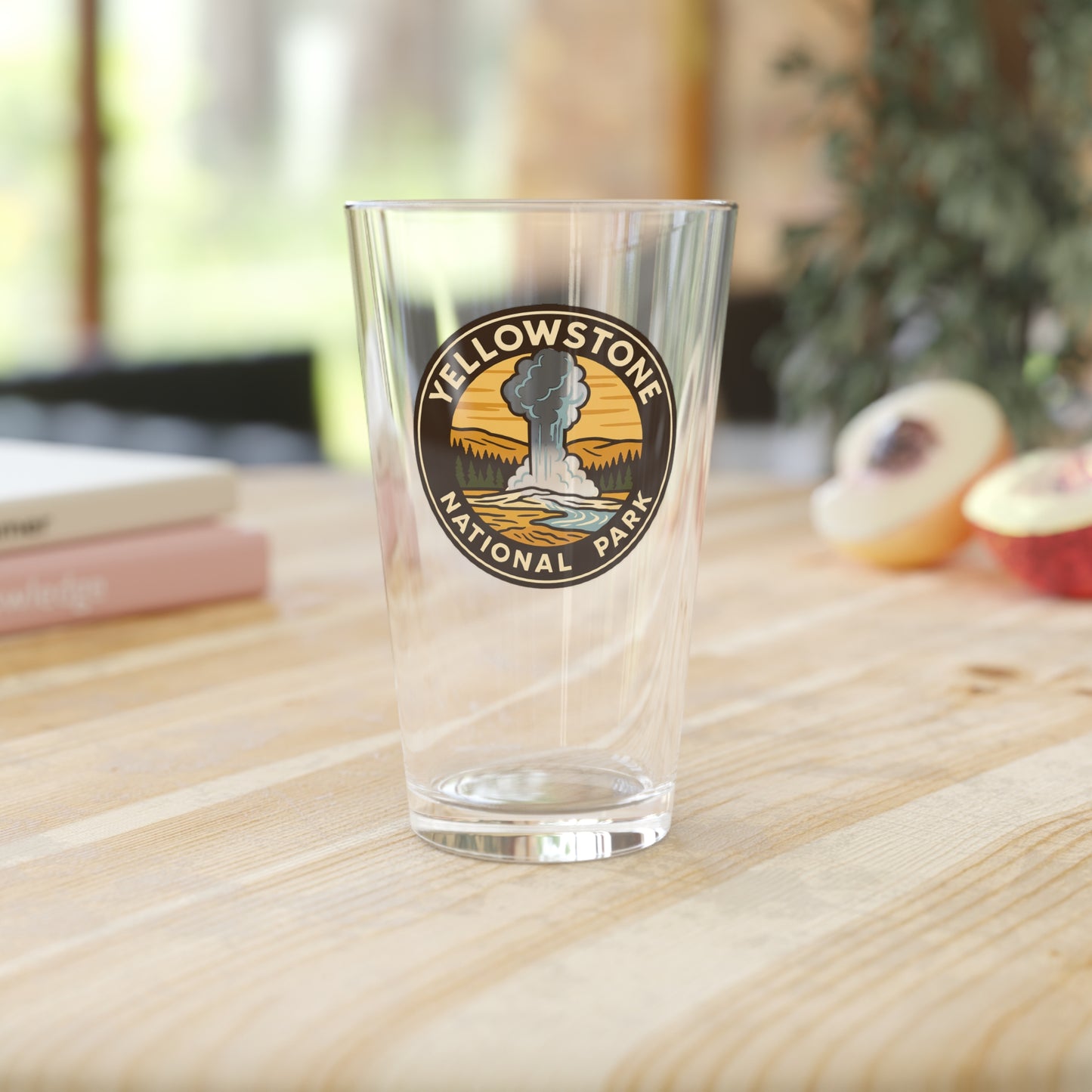 Clear glass with Yellowstone National Park logo on a wooden surface