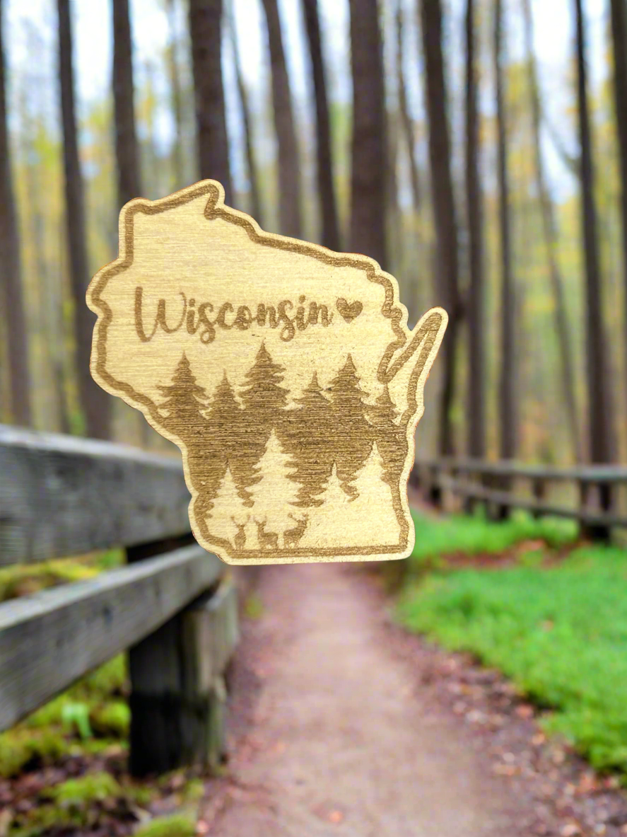 Wisconsin wood shaped magnet with deer and forest scene and text Wisconsin with heart symbol.