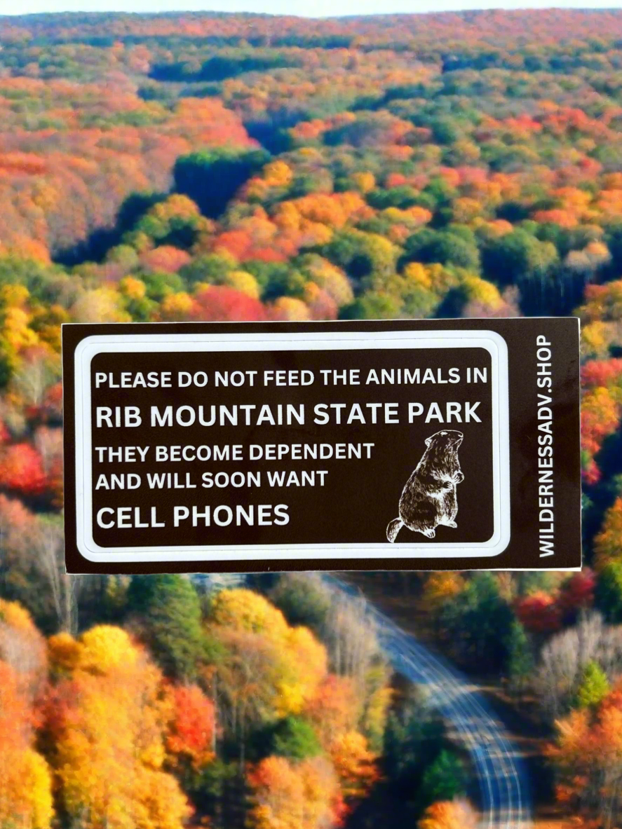 Funny sticker indicating not to feed the animals or they will want cell phones with an outline of a woodchuck.