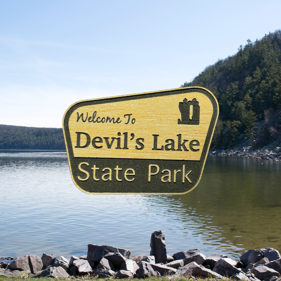 Engraved wood grain acrylic with “Welcome to Devil’s Lake State Park”. Photo background: Devil’s Lake and talus slope.