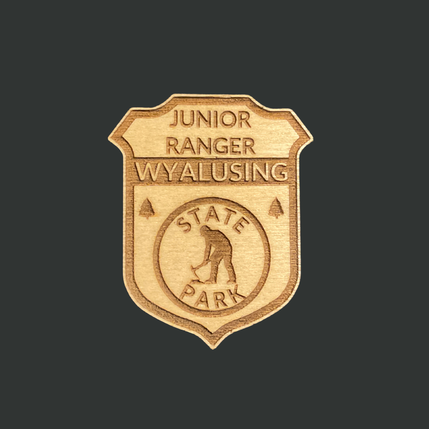 Wooden badge with 'Junior Ranger Wyalusing State Park' and miner icon engraving on a black background