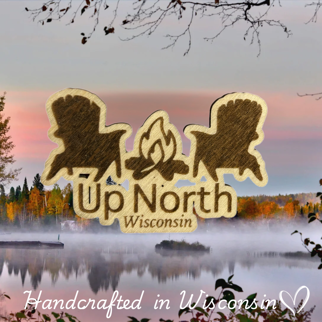 Wood magnet in the shape of two Adirondack chairs and a campfire pictured against a misty lake backdrop.