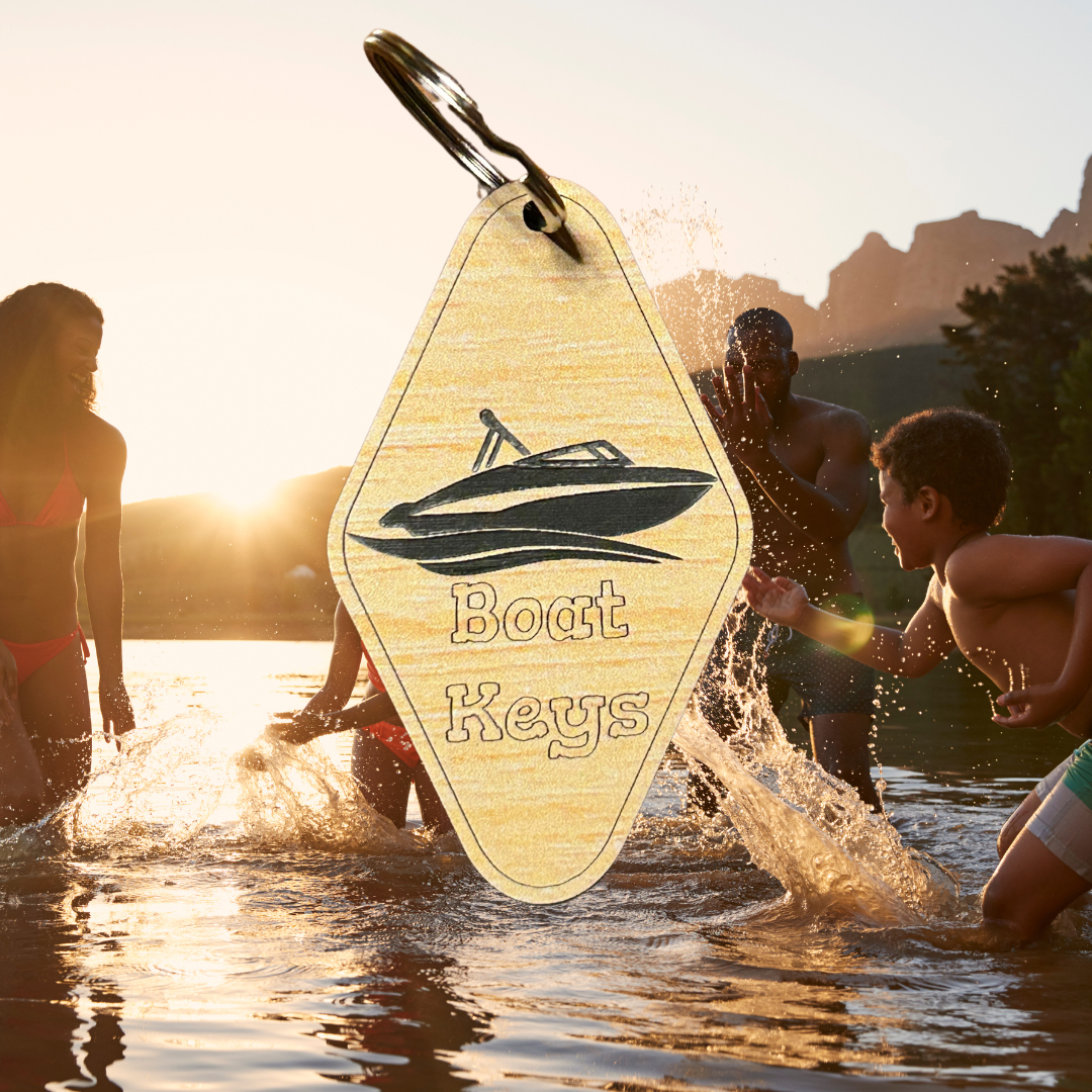 Wood grain acrylic keychains with boat icon and text “boat keys”. Photo background: kids and adults splashing in the lake.