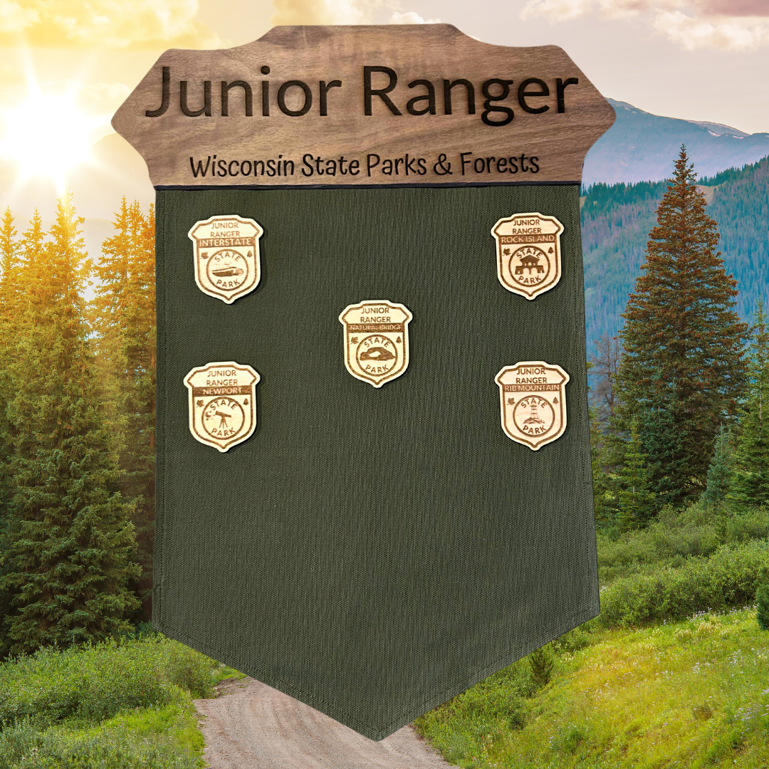 Jr. Ranger banner with walnut wood badge top and green duck canvas banner. Photo background: Mountains at sunset.