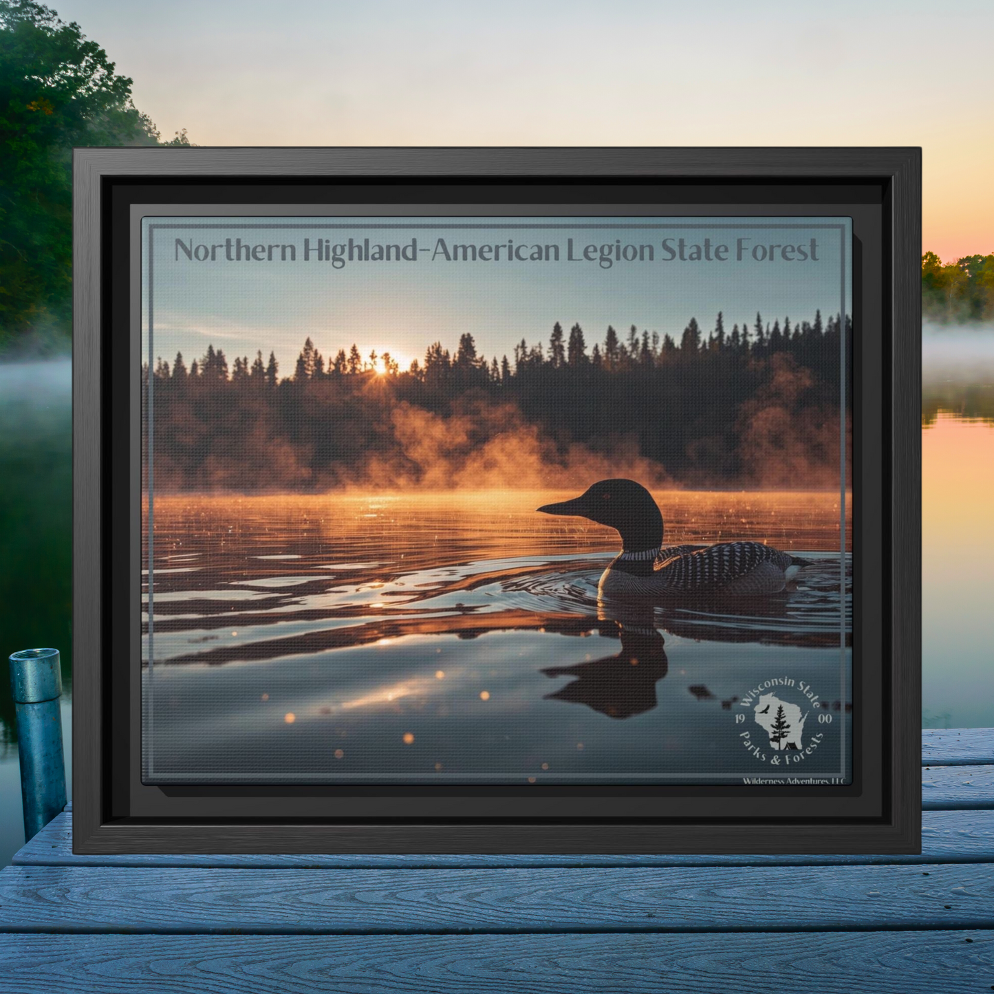 Black framed canvas art depicting a loon swimming on a lake in the early morning as mist rises from the water. Photo background: looking out over a lake in the early morning as mist rises from the water.