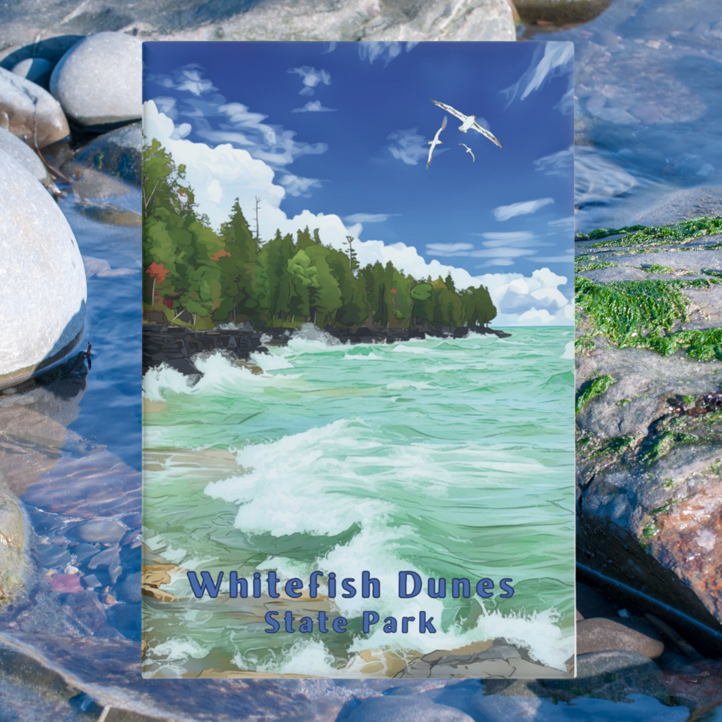 2x3” button magnet featuring a rocky shoreline with waves crashing against the rocks and the text: Whitefish Dunes State Park. photo background: close up of rocks in the water.