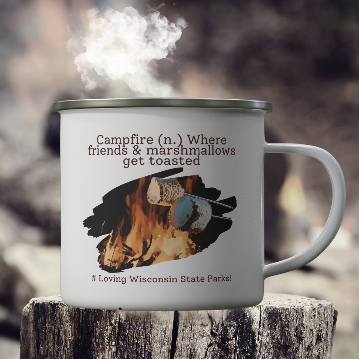 White enamel camper mug on a stump with a graphic design of a marshmallow being roasted over a fire and the text: campfire (n.) where friends and marshmallows get toasted. # loving Wisconsin State Parks”.