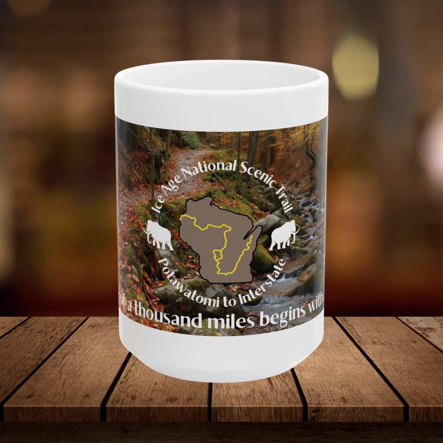 Mug with Ice Age National Scenic Trail design on a wooden surface with a blurred background