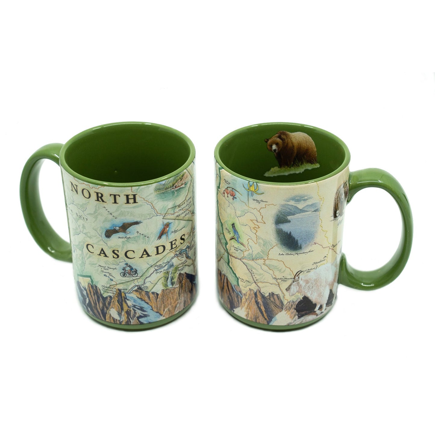 Two views of a ceramic mug with a green handle and interior, featuring a vintage-style map illustration labeled 'NORTH CASCADES' and a small brown bear figurine inside the cup, shown on a white background.