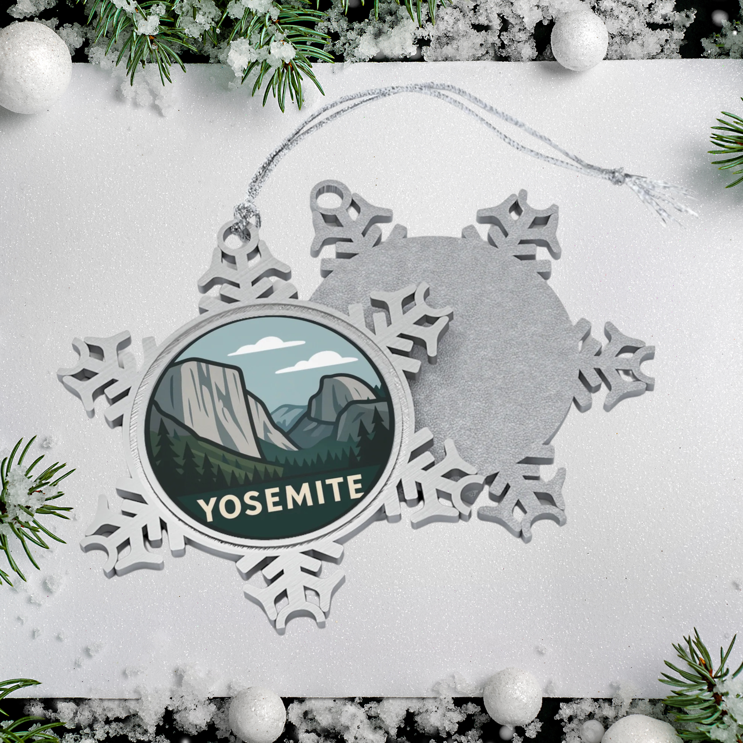 Snowflake-shaped ornament with Yosemite design on a white background