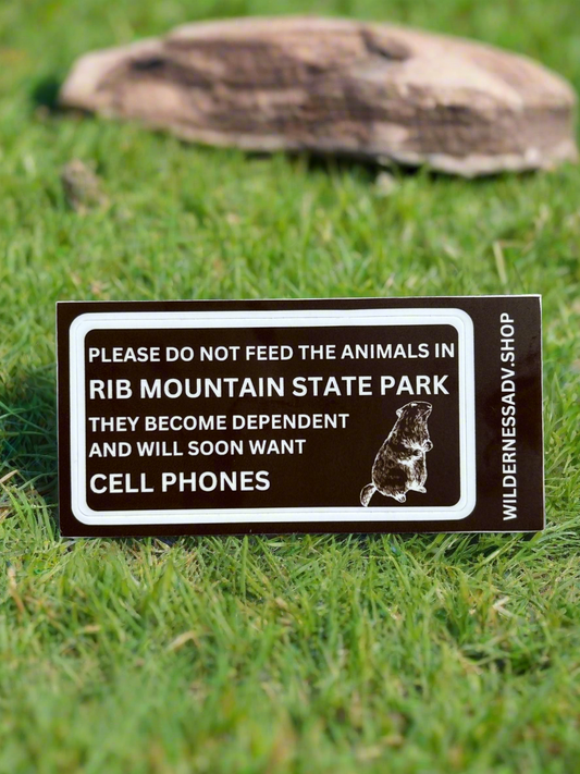 Funny sticker indicating not to feed the animals or they will want cell phones with an outline of a woodchuck.