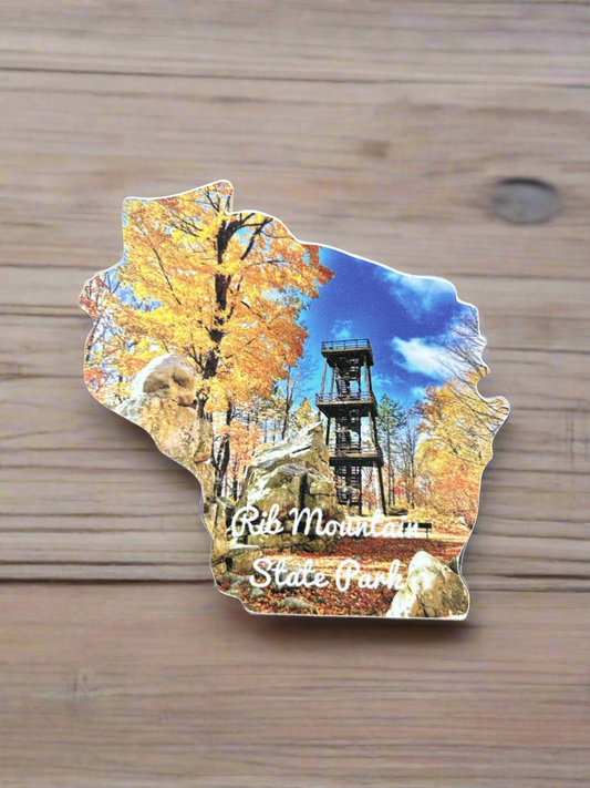 Wisconsin Shaped sticker with a photograph of fall color trees and observation tower, and the text "Rib Mountain State Park". 