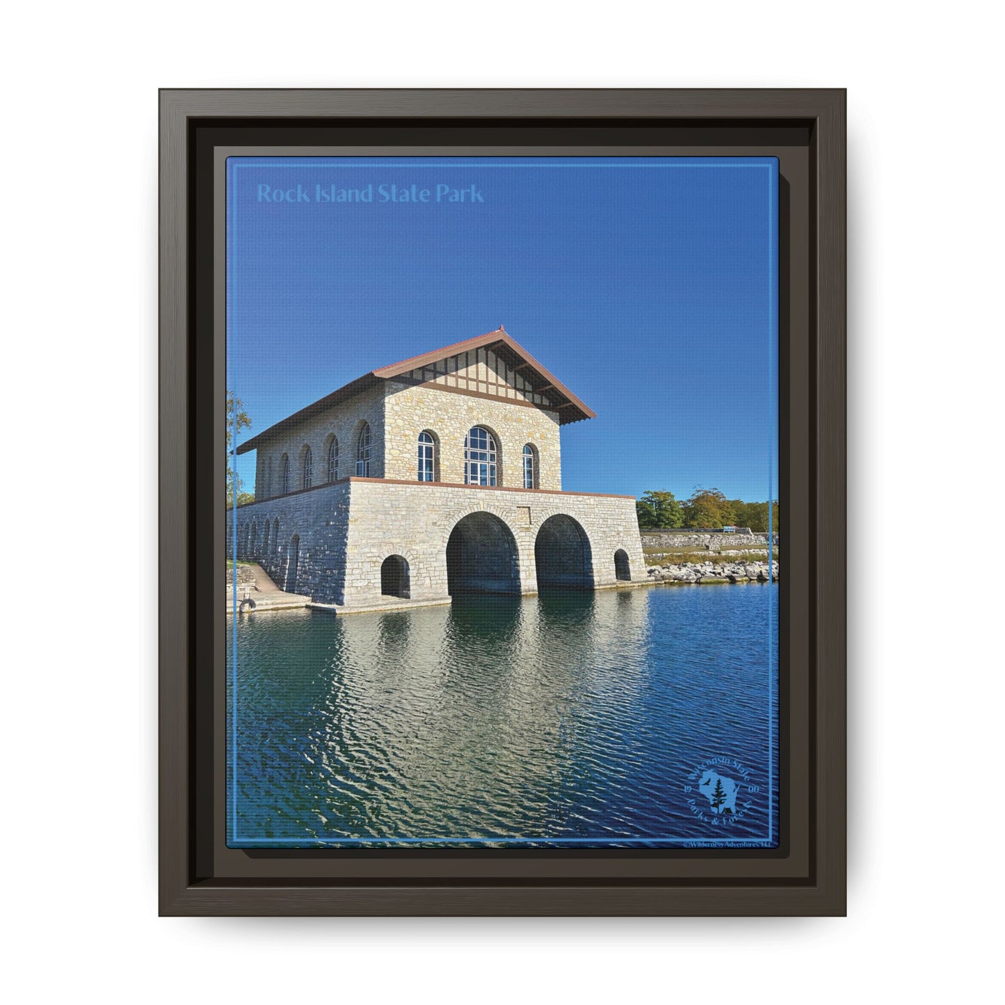 Espresso Framed canvas print featuring the iconic stone boathouse at Rock Island State park set against a clear blue sky and blue water.  