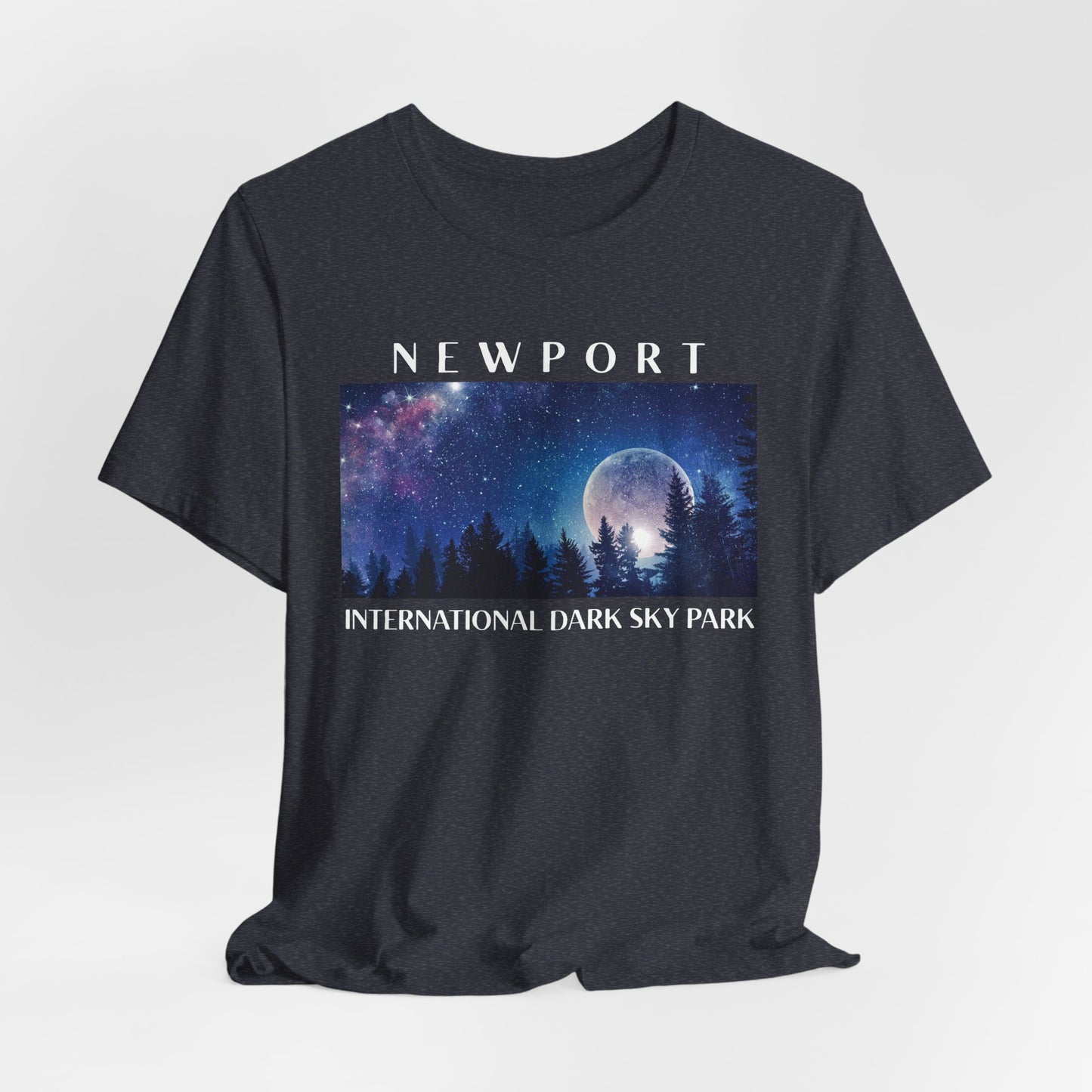 Heather Navy t-shirt with a graphic of a night sky over trees and 'Newport International Dark Sky Park' text.