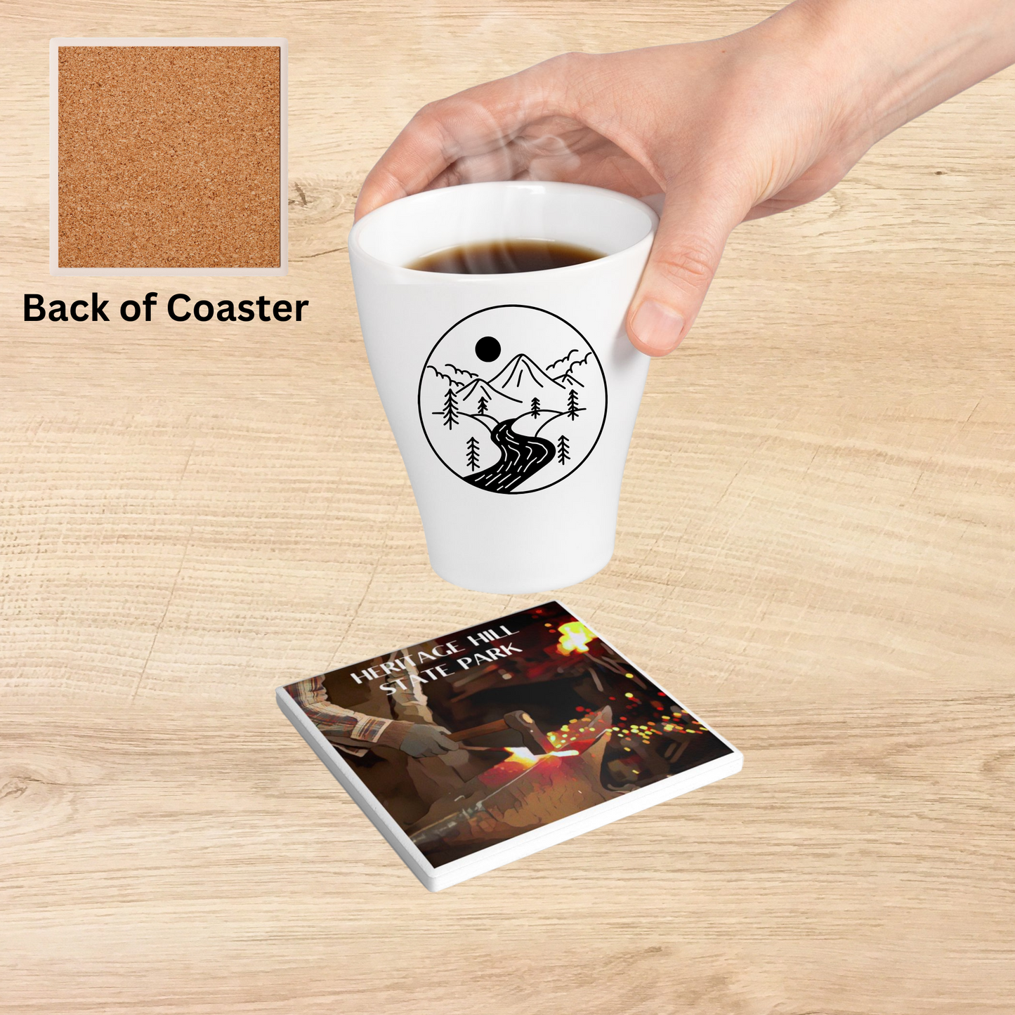 Ceramic Coaster featuring a blacksmith forging steel and the text: Heritage Hill State Park.  Photo background: coaster on a wood counter with individual placing a hot beverage on it. 
