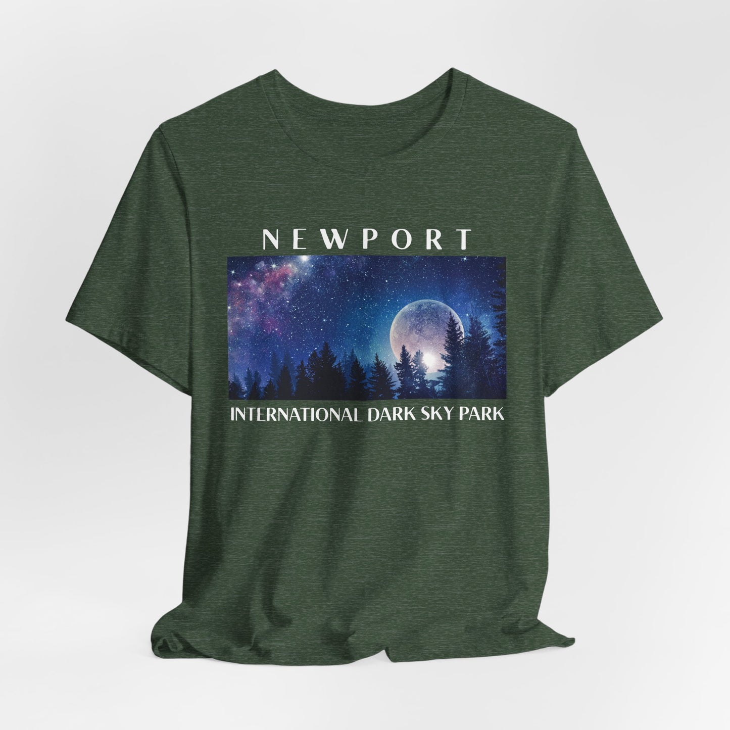 Heather Forest t-shirt with a graphic of a night sky over trees and the text 'Newport International Dark Sky Park' on a white background.