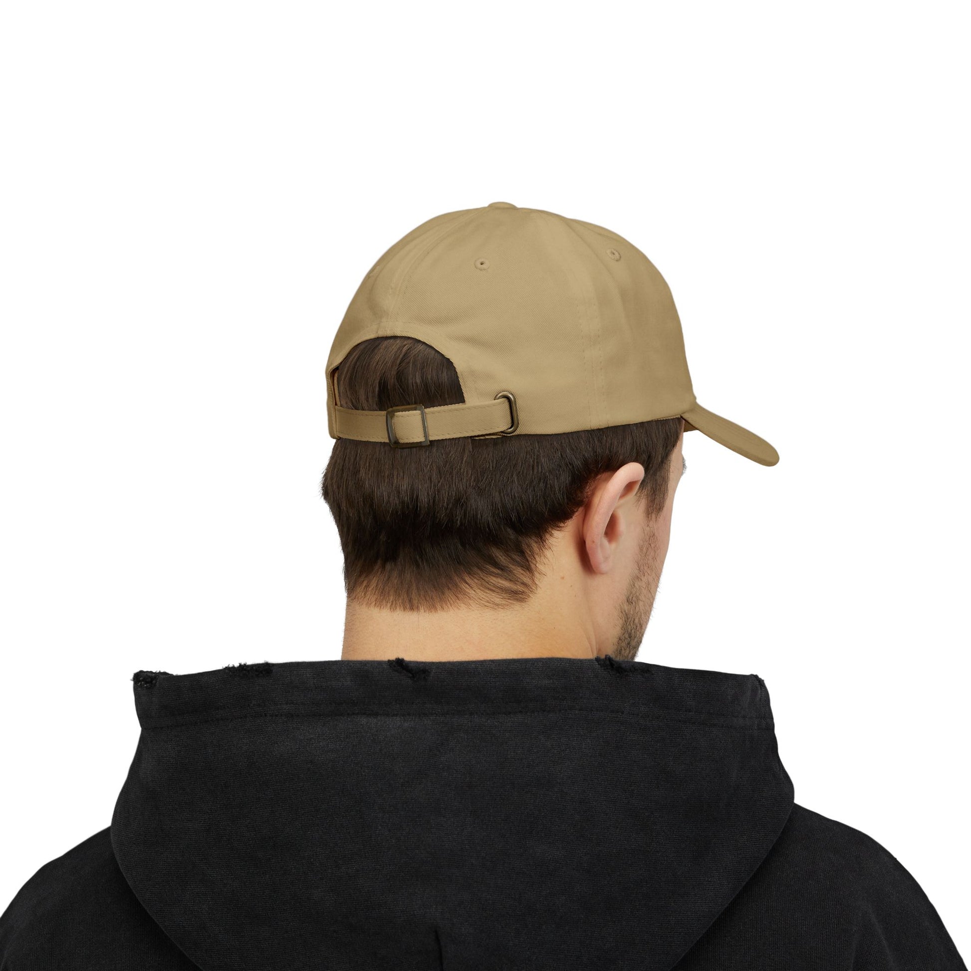 Person wearing a khaki cap and black hoodie on a white background