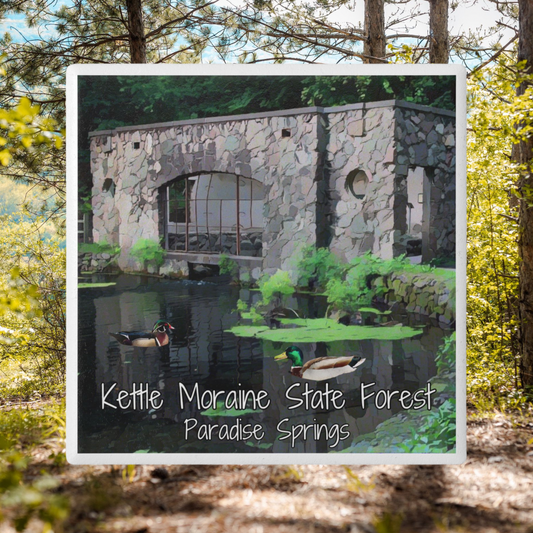 Ceramic Coaster featuring the stone spring house at Paradise Springs.  Features the text “Kettle Moraine State Forest Paradise Springs.”  Photo background: sunny day among pine trees. 