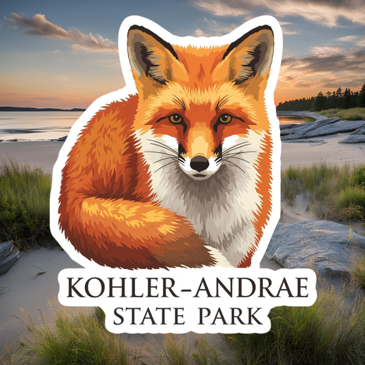 Sticker of a fox with 'Kohler-Andrae State Park' text over a scenic background.