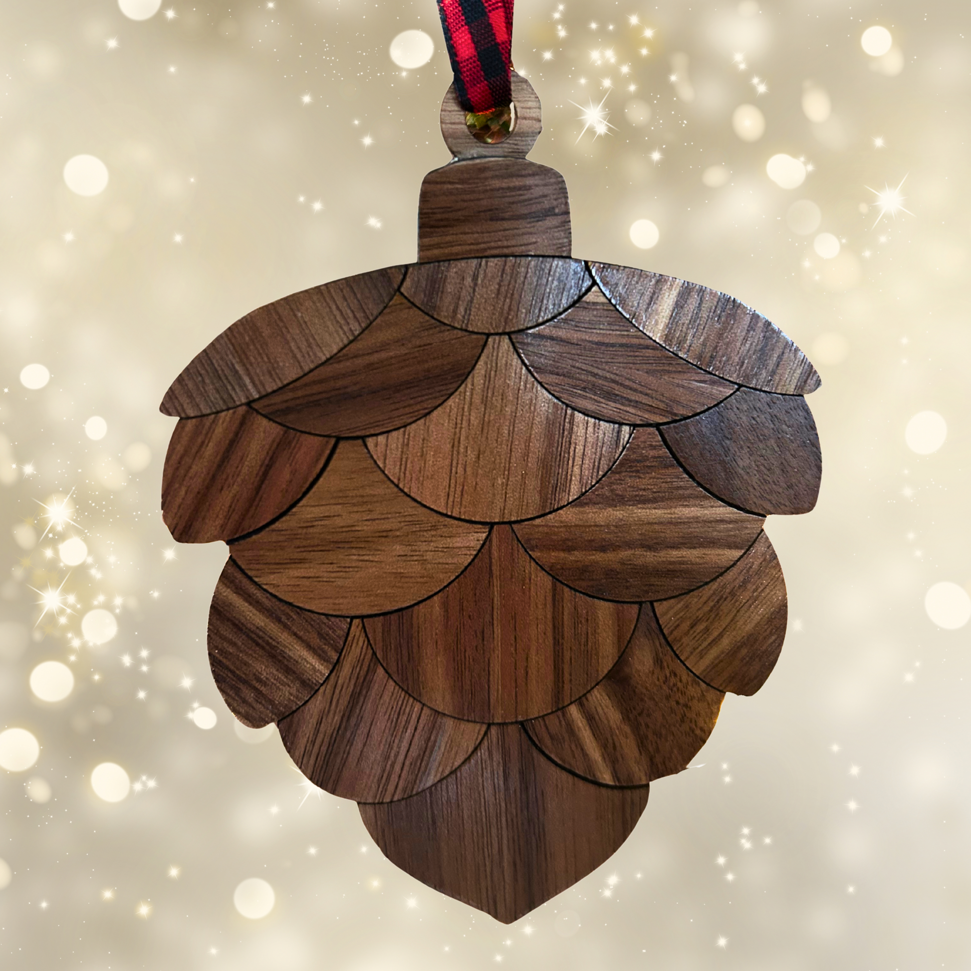 Wooden pine cone ornament on a sparkling background