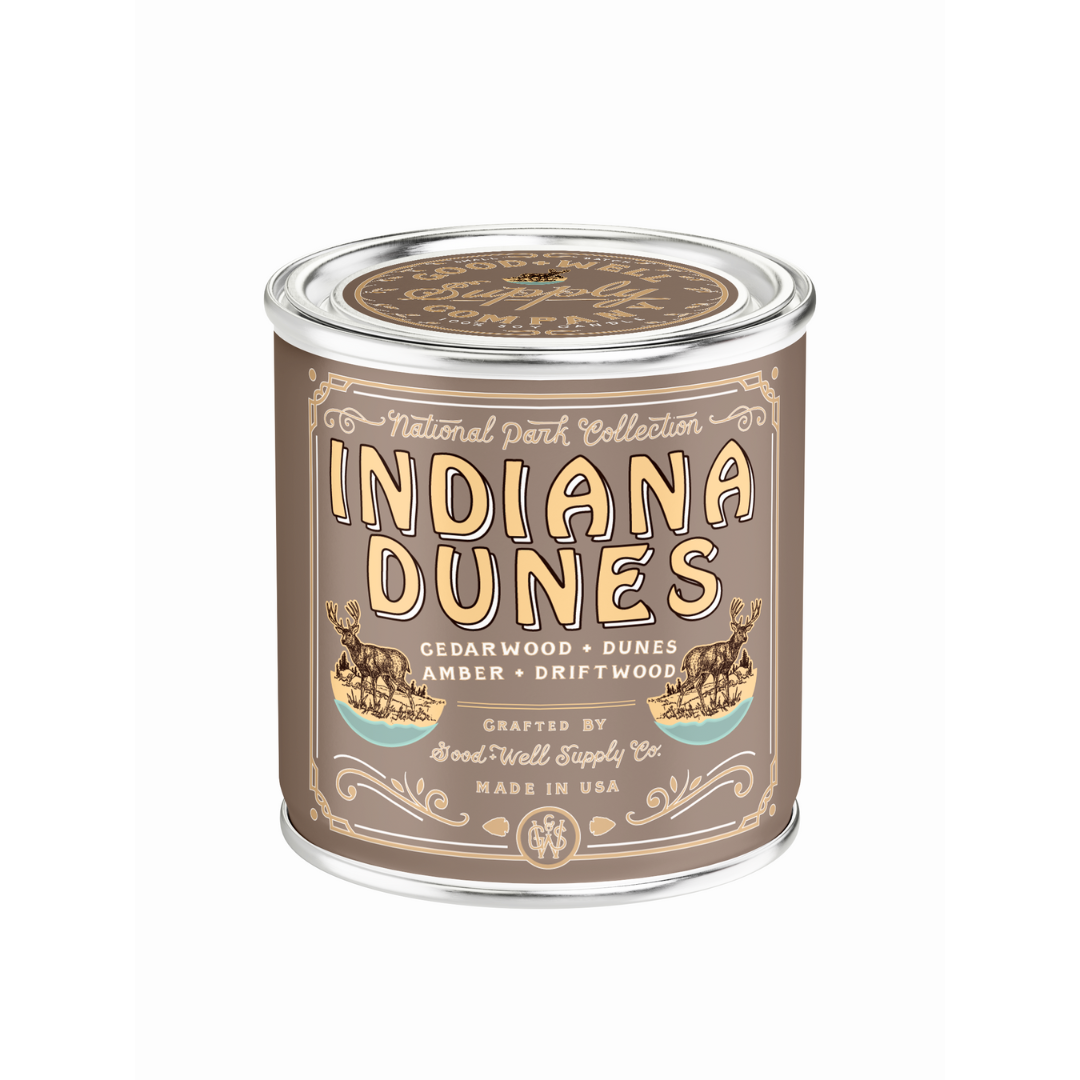Candle canister labeled 'Indiana Dunes' with decorative design on a white background