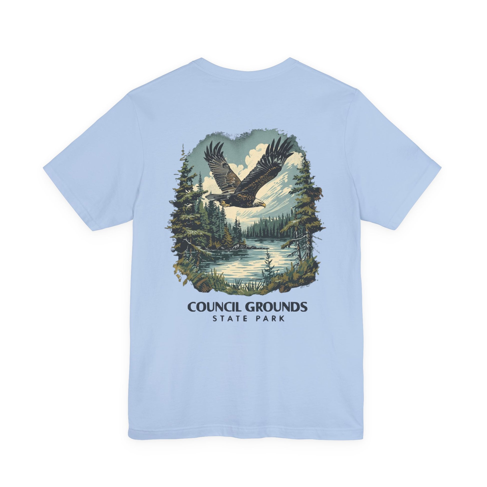 Light blue t-shirt with a eagle graphic and 'Council Grounds State Park' text on a white background