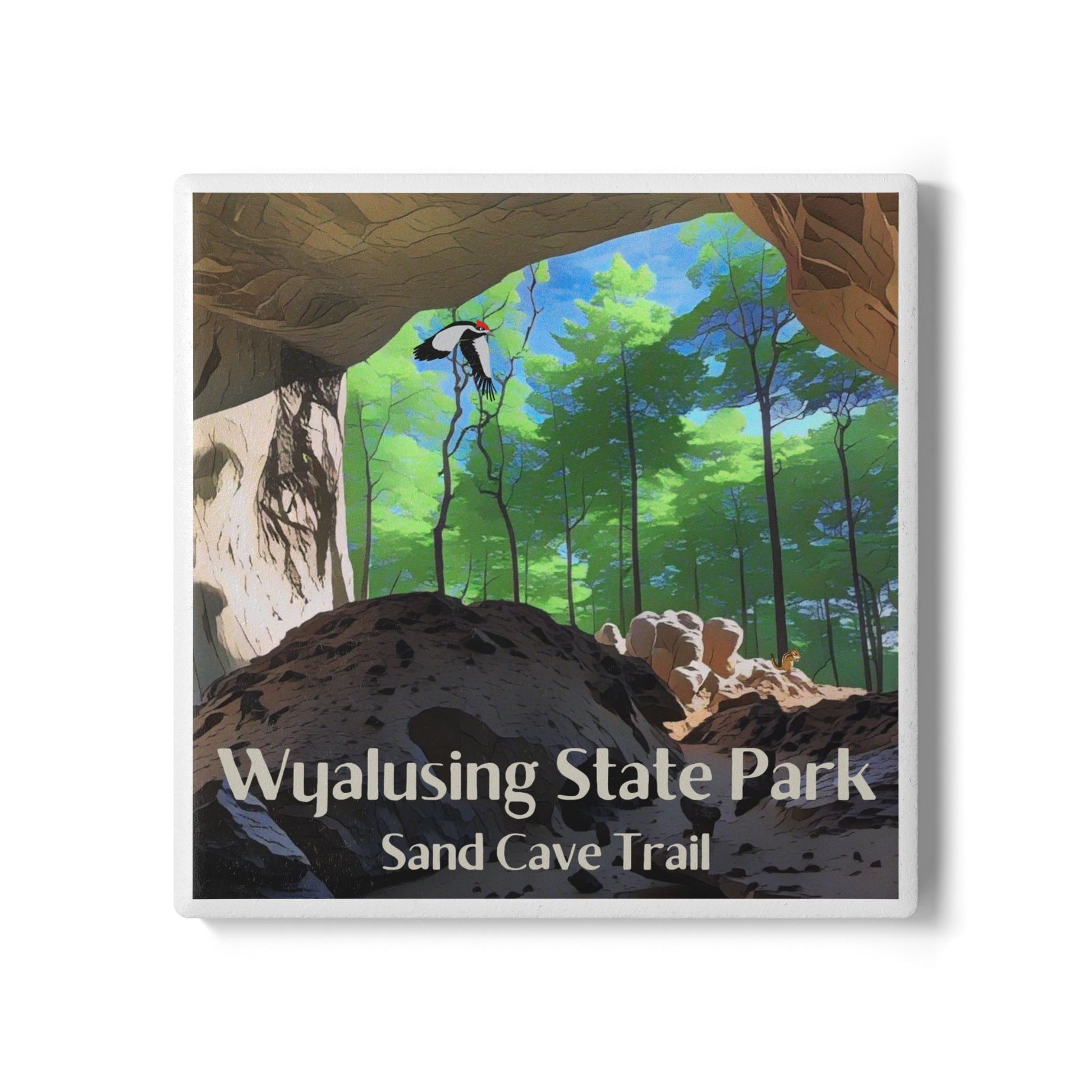 Ceramic coaster featuring a view from inside a sandstone cave looking out into a lush green forest with a woodpecker flying through the air. 