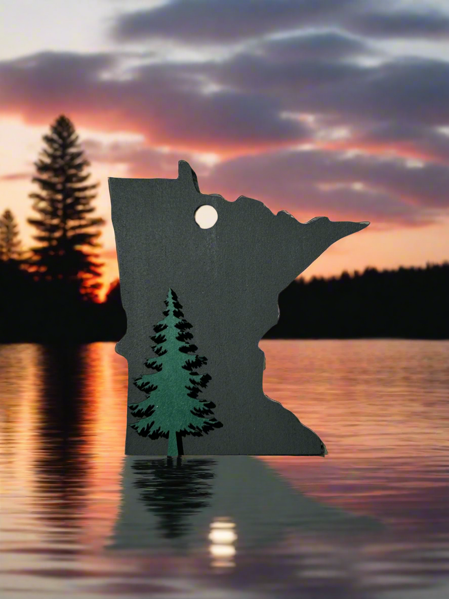 Black Minnesota Shaped ornament with a green pine tree icon. 