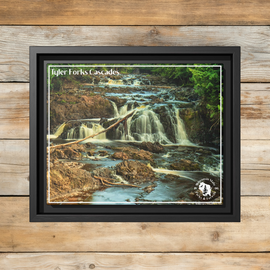 Framed canvas wall art of Tyler Forks Cascades in a black dimensional frame.  Photo Background: rustic barn wood boards.