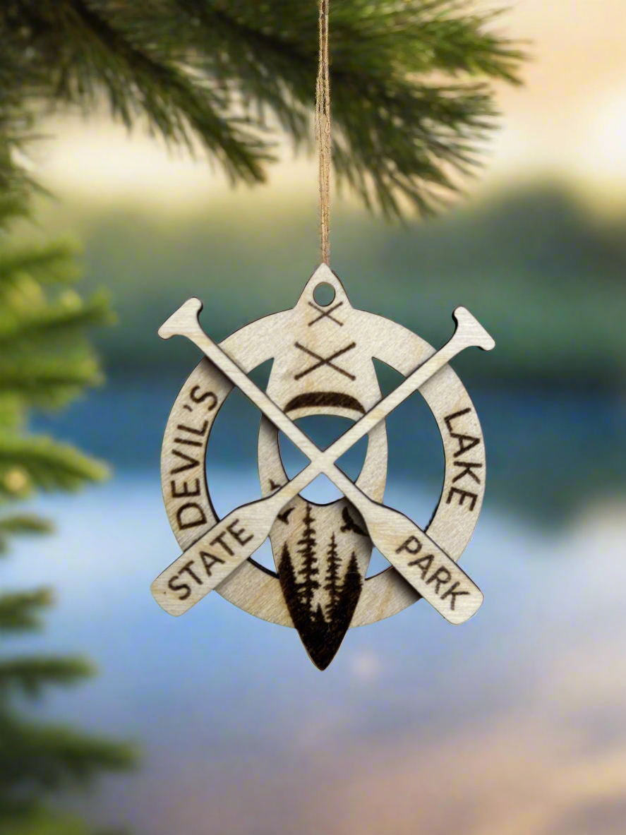 Wood ornament with the text "Devil's Lake State Park" and kayak with crossed paddles. 