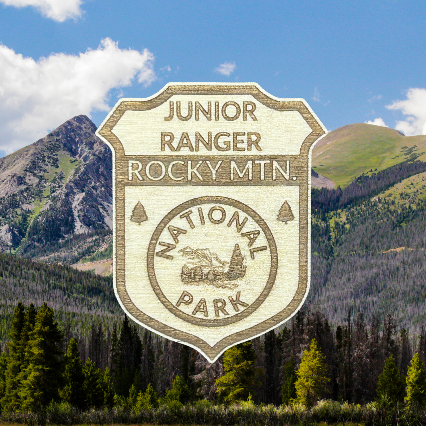 Junior Ranger Rocky Mountain National Park badge with mountain landscape in the background
