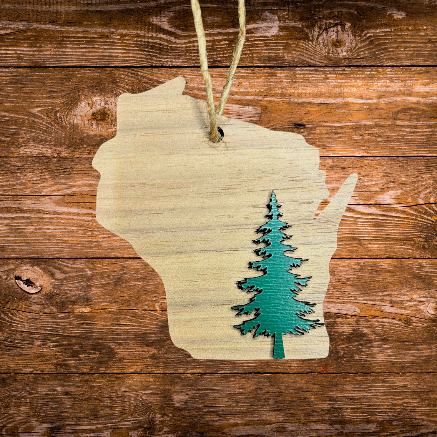 Walnut Wisconsin ornament with a Green tree on wood background.