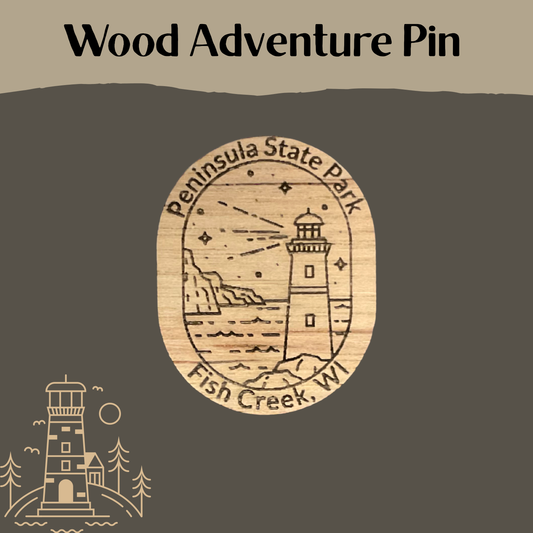 Wooden pin with lighthouse design and 'Peninsula State Park' text on a dark background