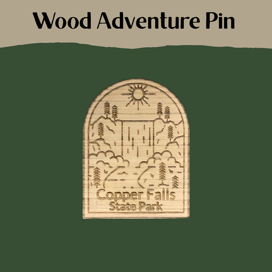 Wooden adventure pin with 'Copper Falls State Park' design on a green background