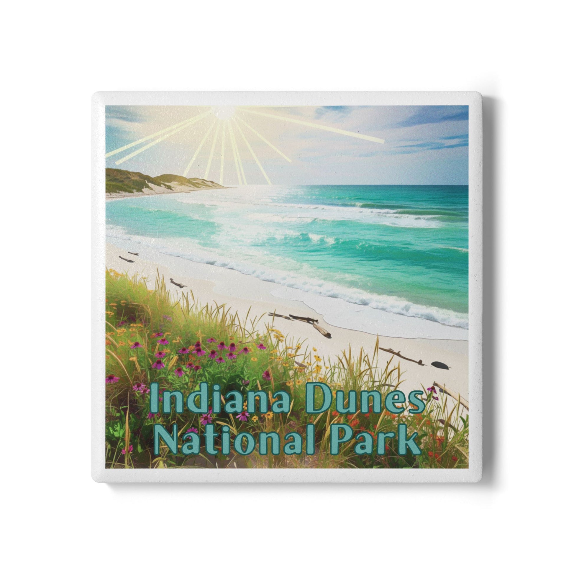 A square ceramic coaster depicting a beach scene labeled 'Indiana Dunes National Park,' with turquoise ocean water, white sand, grassy dunes, and a bright sunburst in the sky.